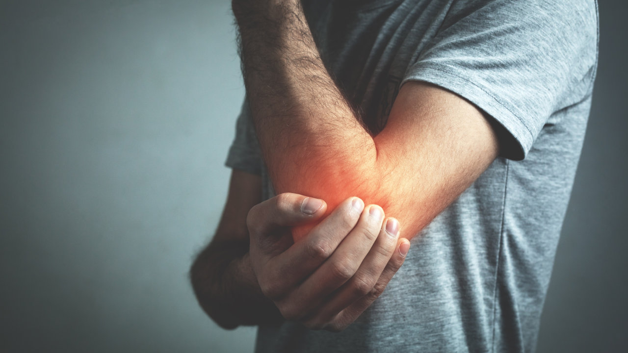 A man rubs a sprained elbow. Learn more about meloxicam here.