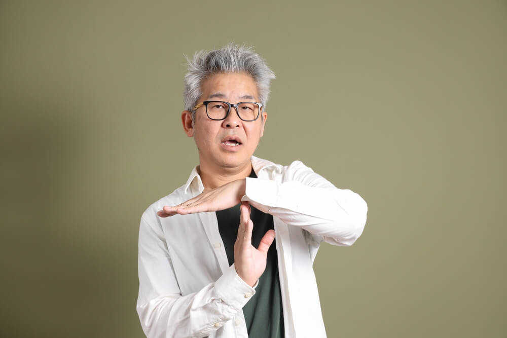 A doctor motioning to stop or time out. Learn more about how to stop enabling an addict here.