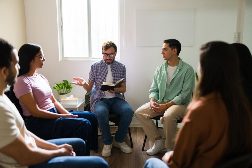 A group of people reading at a support group. Read the list of NA meeting topics sorted by step, here.