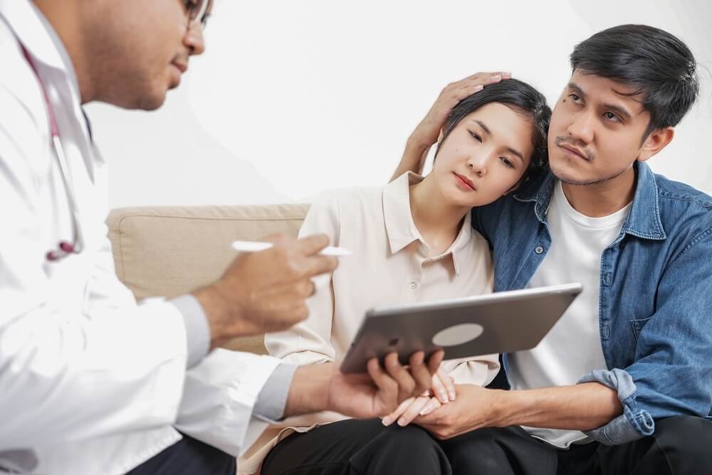 A doctor showing test results to a couple
