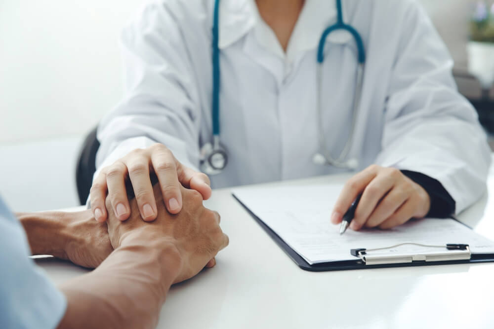 A doctor comforting a patient