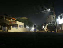 A man standing in the middle of a dark street at night. Learn more about opium street names here.