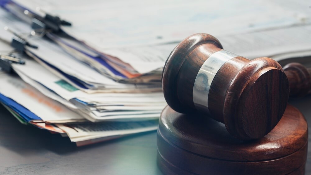A gavel sitting next to a collection of legal papers. Learn more about the Schedule 3 narcotics list here.