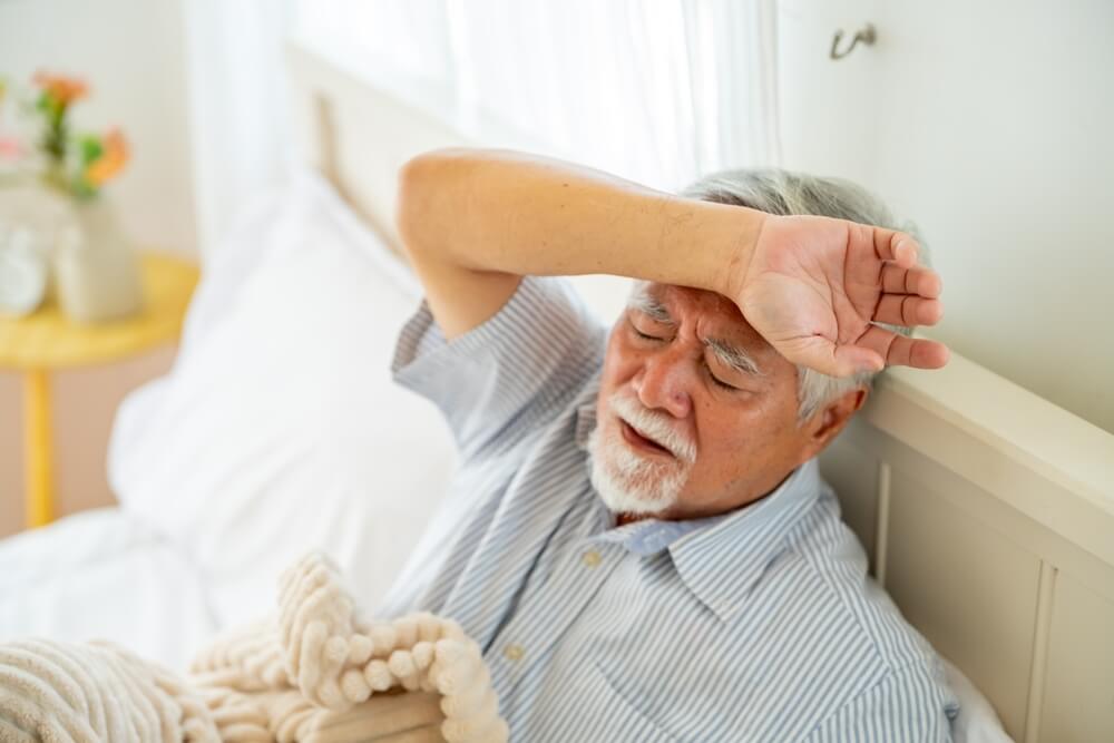 An elderly man wipes his brow. Learn more about treatment for meloxicam addiction here.