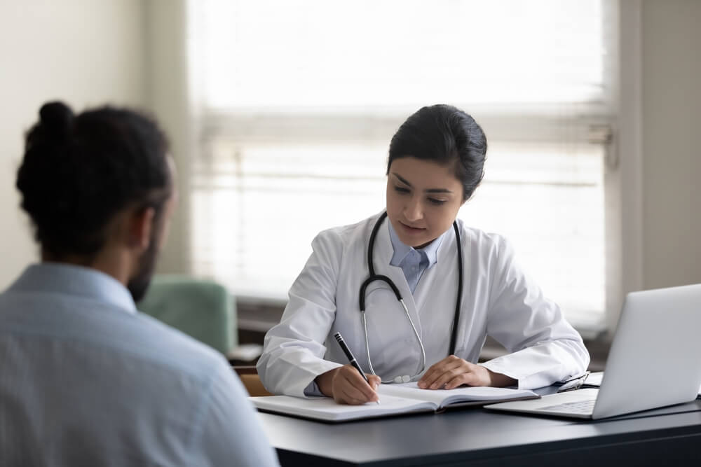 A person speaking with a doctor. Learn more about treatment for percocet addiction here