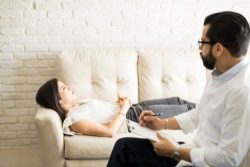woman on couch guided by therapist
